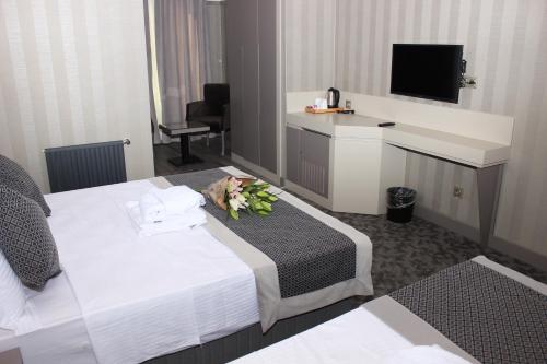 a hotel room with a bed and a television at Anka Premium Hotel in Istanbul