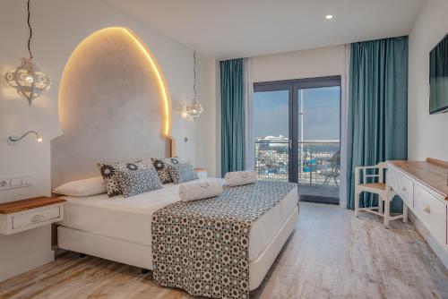 a bedroom with a bed and a large window at La Residencia Puerto Hotel & Spa in Tarifa