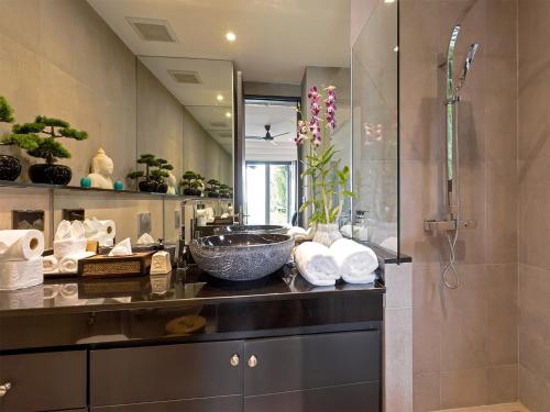 a bathroom with a sink and a shower at Infinity Blue Phuket by Elite Havens in Natai Beach