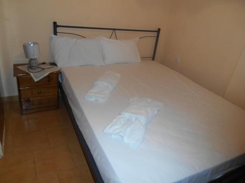 a bedroom with a bed with two towels on it at Melios Rooms in Petalidhion