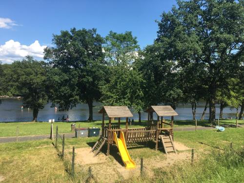 a park with a playground with a slide at Camping de la Bageasse in Brioude