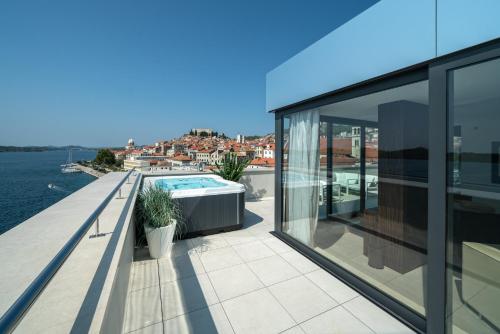 a balcony of a house with a swimming pool at Bellevue Superior City Hotel in Šibenik