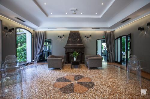 a living room with chairs and a fireplace at Savoia Hotel Country House Bologna in Bologna