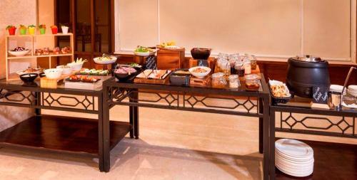 a table with a bunch of food on it at Lemon Tree Hotel Lucknow in Lucknow