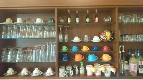 a shelf filled with lots of glass vases at Chong Er Ya She Homestay in Jiji