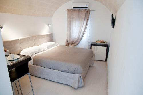a small bedroom with a bed and a window at B & B Sotto la Volta in Massafra