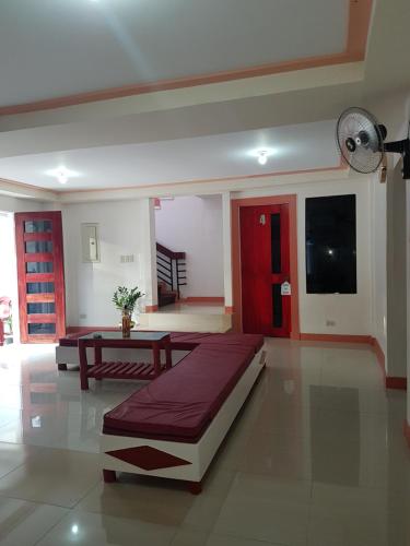 a room with a bed and a table in it at Catalina`s Inn family room in Panglao