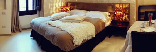 a bedroom with a large bed with white pillows at B & B Sotto la Volta in Massafra