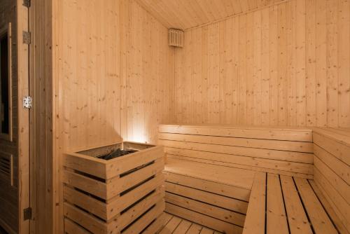 a wooden sauna with a wooden tub in it at Roygent Parks Hanoi in Hanoi
