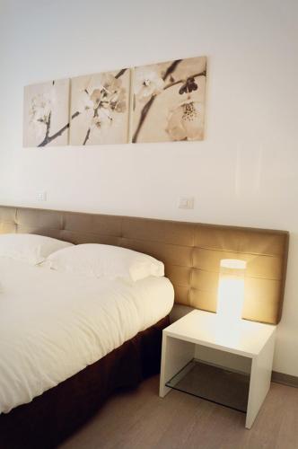 a bedroom with a bed and a table with a lamp at B & B Sotto la Volta in Massafra