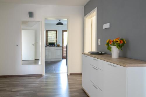 a kitchen with a counter with a vase of flowers at Business Wohnung ++ hochwertige Ausstattung in Paderborn
