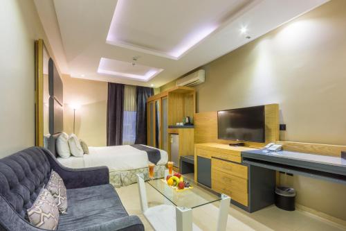 a hotel room with a bed and a television at Al Muhaidb Takhasosi Value in Riyadh