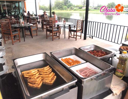 a table with two trays of food on a grill at Chabana Resort Bang-tao Beach Phuket- SHA Extra Plus in Bang Tao Beach