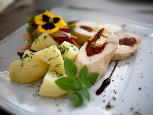 a plate of food with cheese and vegetables on it at Ośrodek Turystyczny Warzenko in Warzenko