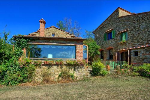 a house with a large window on the side of it at Gellino by PosarelliVillas in Misciano