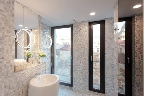 a bathroom with a sink and a mirror at Filitti Boutique Hotel in Bucharest