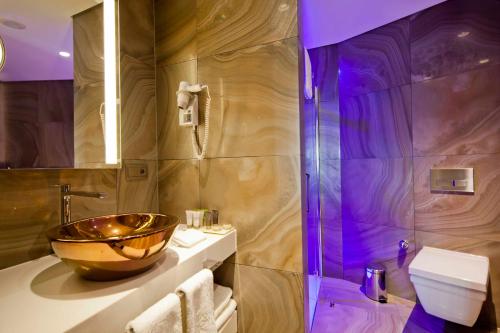 a bathroom with a bowl sink and a shower at Lasagrada Hotel Istanbul in Istanbul