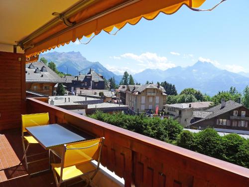 a table and chairs on a balcony with a view at Apartment Grand-Hôtel B35 by Interhome in Villars-sur-Ollon