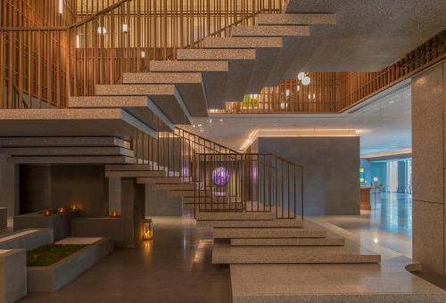 a spiral staircase in a building with a lobby at The Sukhothai Shanghai in Shanghai