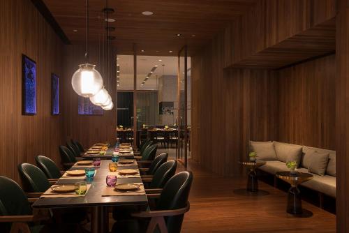 a long dining room with a long table and chairs at The Sukhothai Shanghai in Shanghai