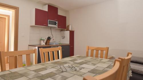 a kitchen with a table and chairs in a room at Apartments Villa Deja in Jahorina