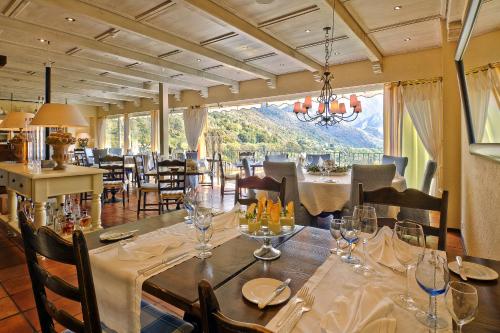 a dining room with tables and chairs and a large window at Ristorante della Stazione da YanElo in Intragna