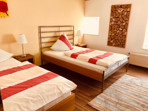 a hotel room with two beds and a rug at Ferienwohnungen "Am Mühlteich" in Radeburg