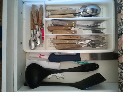 a refrigerator filled with lots of kitchen utensils at Monoambiente en Mendoza in Mendoza
