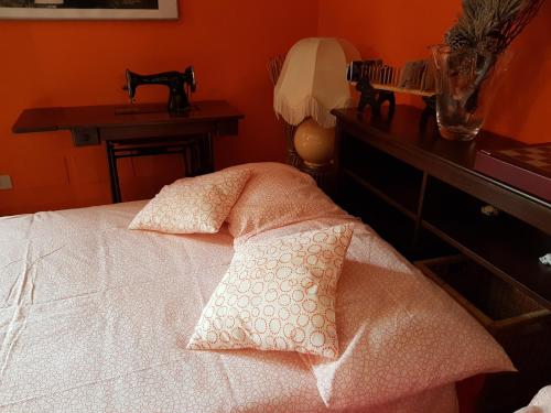 a bedroom with a bed with two pillows on it at B&B Vista su Roma in Marco Simone