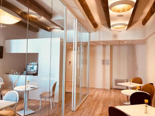 a room with tables and chairs and a glass wall at Palazzo Otello 1847 Wellness & Spa in Vicenza