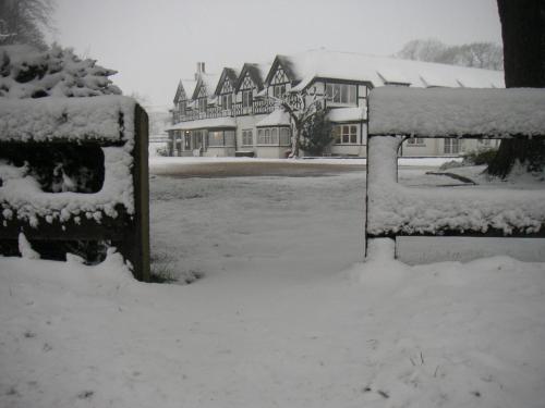 a snow covered yard in front of a house at South Lawn Hotel in Lymington