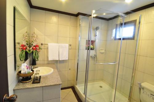 a bathroom with a shower and a sink at Top North Hotel in Chiang Mai