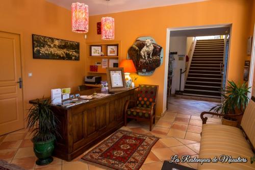 a home office with a desk and a couch at Hotel Les Restanques De Moustiers in Moustiers-Sainte-Marie