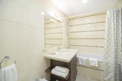 a bathroom with a sink and a bath tub at SPA Hotel Galera in Kyiv
