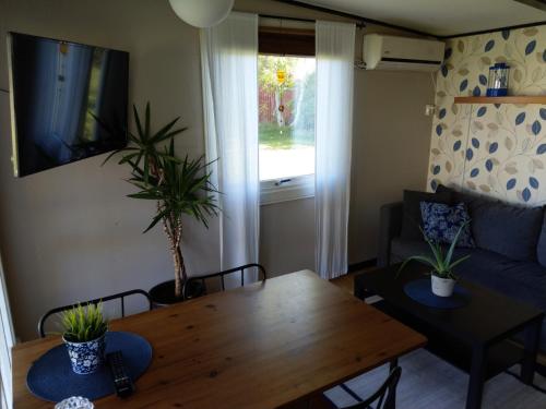 a living room with a table and a couch at Kvarngården Natur Resort in Byxelkrok