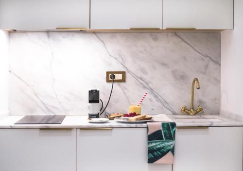 a kitchen with a counter with a cake and a sink at Casa Timoteo Apartamentos Boutique Adults Only in Alcoy