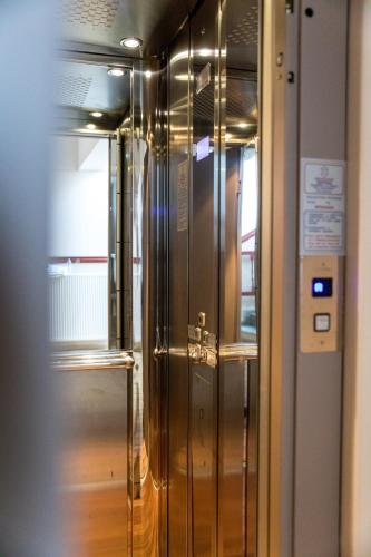 a glass elevator in a building with a door at Tasia Mountain Hotel in Chania