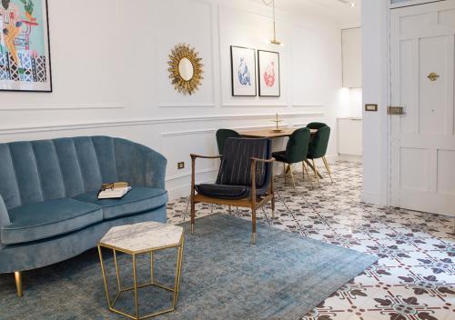a living room with a couch and a table and chairs at Casa Timoteo Apartamentos Boutique Adults Only in Alcoy