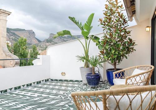 a balcony with plants and a table and chairs at Casa Timoteo Apartamentos Boutique Adults Only in Alcoy