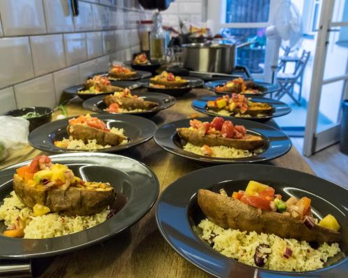 a row of plates of food on a table at The RoadHouse Prague in Prague