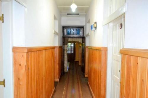 a hallway of a building with wooden flooring and a hallwayngth at Highcliffe Guest House in Haputale