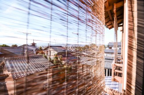 a view of a city from a window with blinds at Kyo no Yado Sangen Ninenzaka in Kyoto