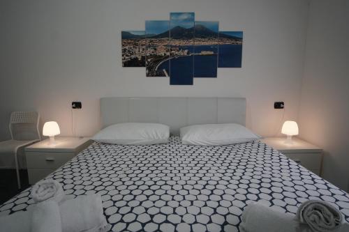 a bedroom with a large bed with two lamps on it at Ciro BED AND BREAKFAST la villetta in Pioltello