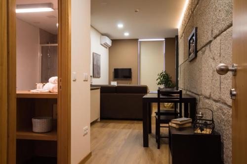 a living room with a couch and a table at Bugalha My Loft Douro 2 in Peso da Régua