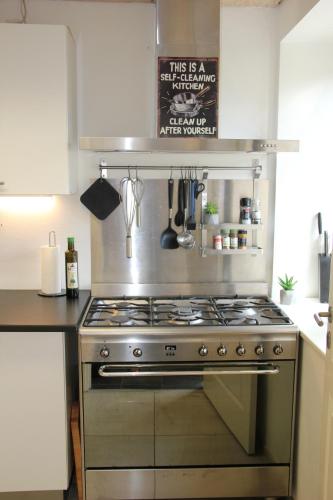 a kitchen with a stainless steel stove top oven at Munkebjerg Bed & Breakfast in Børkop
