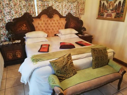 a bedroom with two beds with white sheets at Tzaneen Guest House in Tzaneen