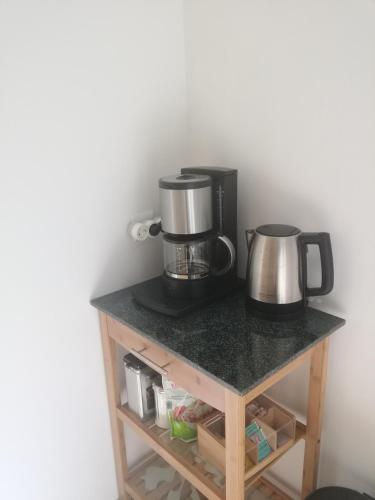a counter with two coffee makers on top of it at Moderne Wohnung in Elz in Elz