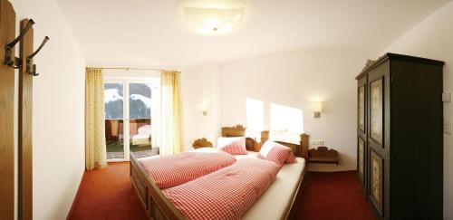 a living room with a couch and a window at Haus Schmetterling in Alpbach