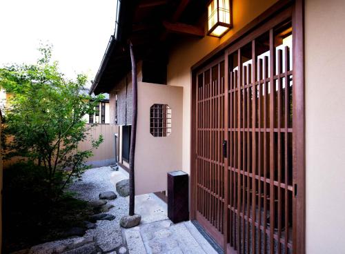 an entrance to a house with a red gate at Kyo no Yado Sangen Ninenzaka in Kyoto
