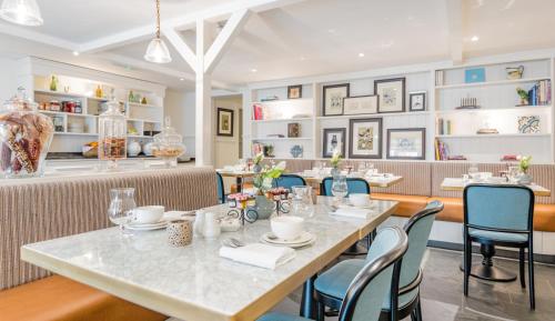 a dining room with a table and chairs at Didsbury House Hotel in Manchester
